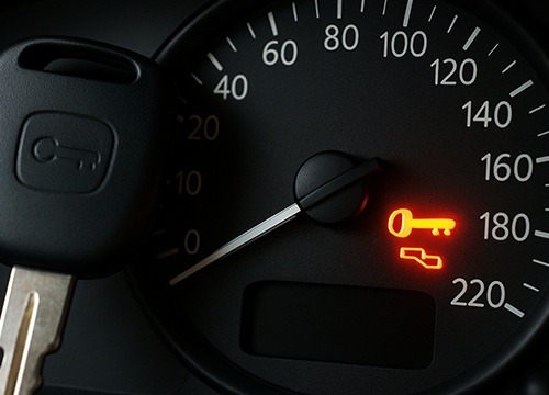 Flashing dashboard warning light indicating car issue requiring attention